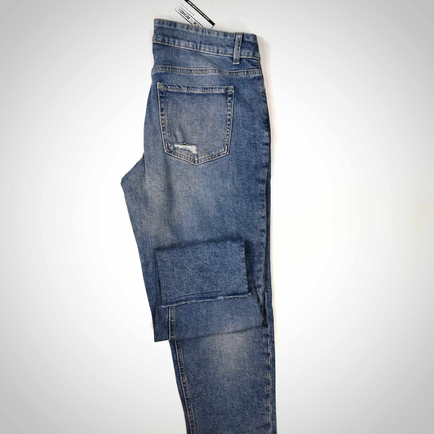 Jeans bleu pale avec trous, jambes étroites, taille haute